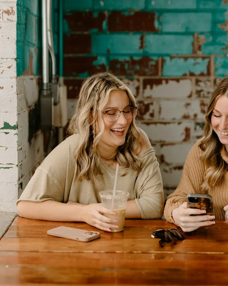 Deux amies regardent le menu sur un téléphone